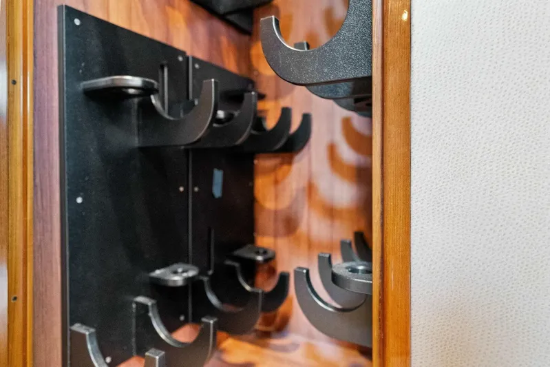 Knot On Call Yacht Photos Pics Wine rack inside 2006 Viking 61 Convertible yacht, featuring wooden and metal design.