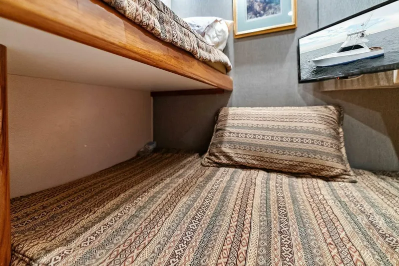 Knot On Call Yacht Photos Pics Cozy cabin interior of 2006 Viking 61 Convertible yacht with patterned bedding.