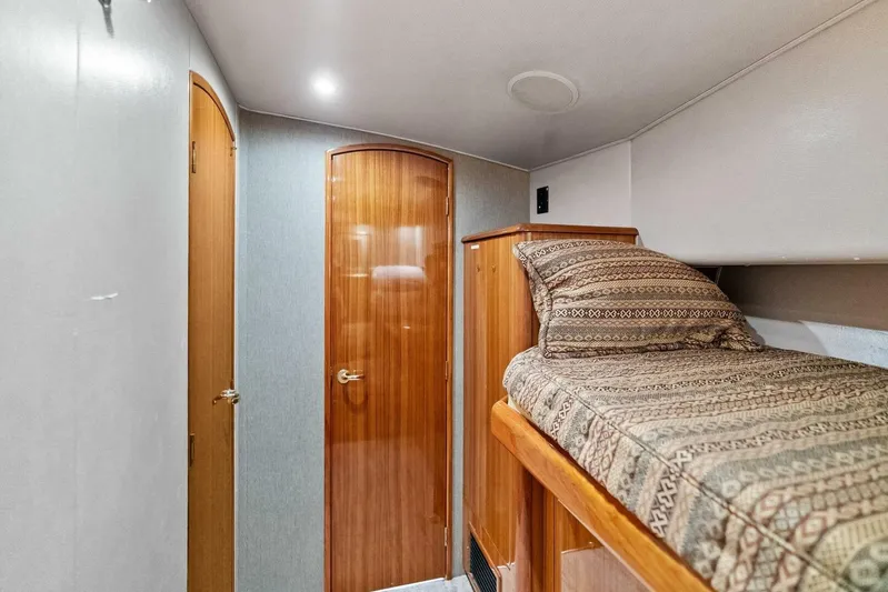 Knot On Call Yacht Photos Pics 2006 Viking 61 Convertible yacht interior with wooden doors and patterned bedding.