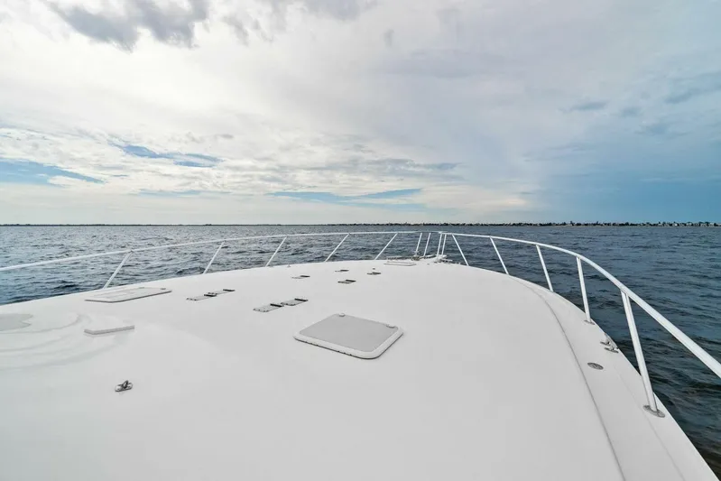Knot On Call Yacht Photos Pics Bow view of 2006 Viking 61 Convertible yacht on open water under cloudy sky.