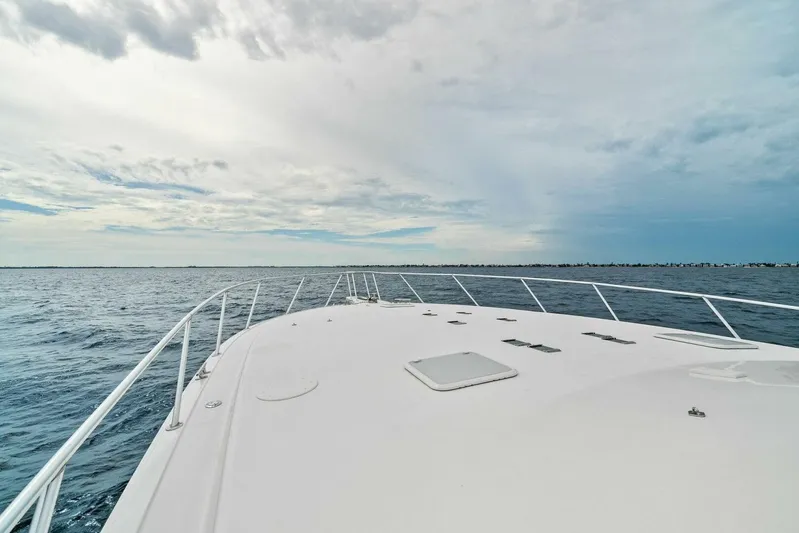 Knot On Call Yacht Photos Pics Bow view of 2006 Viking 61 Convertible yacht on open sea under cloudy sky.