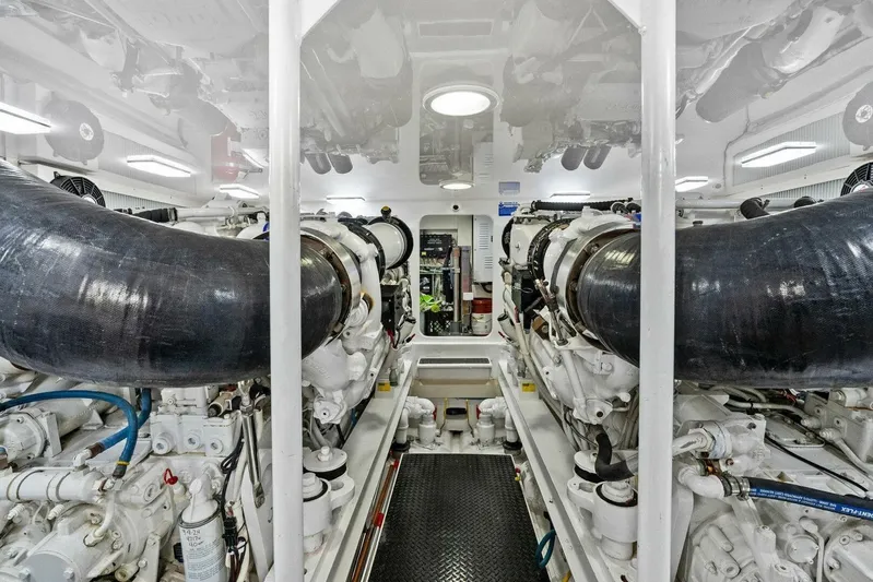 Knot On Call Yacht Photos Pics Engine room of 2006 Viking 61 Convertible yacht, showcasing powerful machinery and clean design.