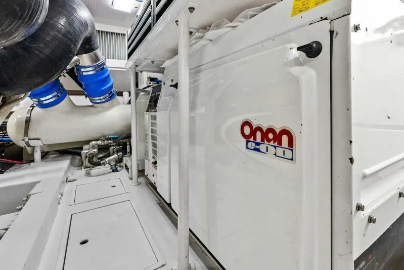 Knot On Call Yacht Photos Pics Engine room of 2006 Viking 61 Convertible with Onan generator and blue hoses.