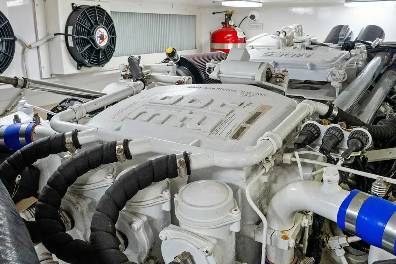 Knot On Call Yacht Photos Pics Engine room of a 2006 Viking 61 Convertible yacht, showcasing detailed machinery.