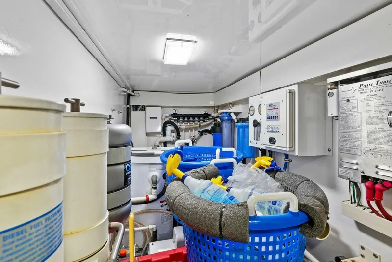 Knot On Call Yacht Photos Pics Engine room of 2006 Viking 61 Convertible yacht with equipment and cleaning supplies.