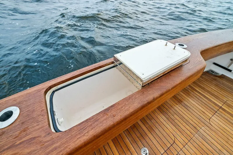 Knot On Call Yacht Photos Pics Open storage compartment on 2006 Viking 61 Convertible yacht with wooden deck and ocean view.