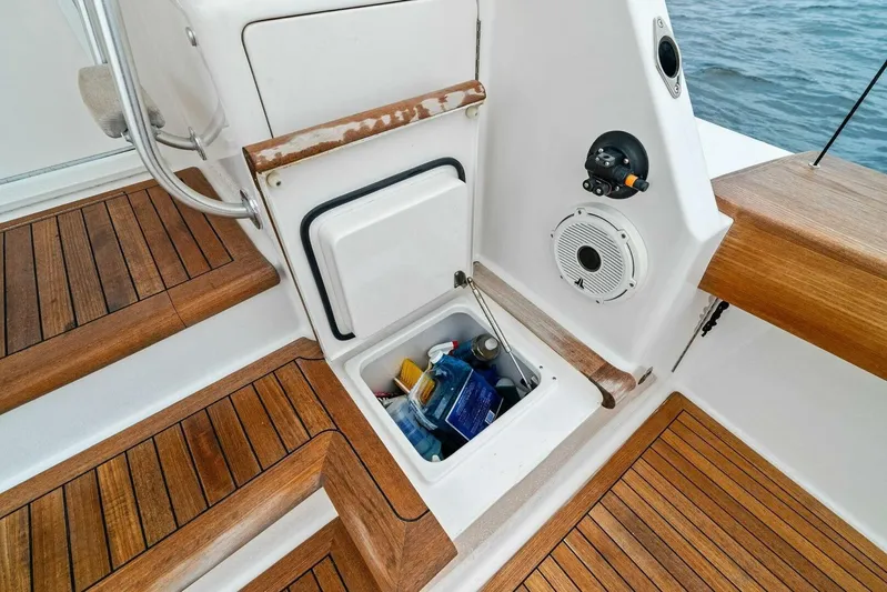 Knot On Call Yacht Photos Pics 2006 Viking 61 Convertible yacht deck with storage compartment and wooden flooring.