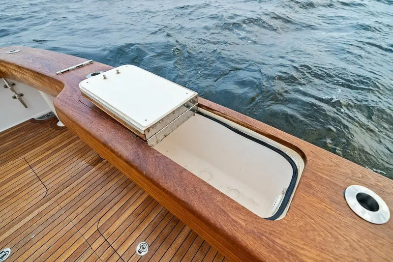 Knot On Call Yacht Photos Pics 2006 Viking 61 Convertible yacht deck with open storage compartment, wooden finish, ocean view.