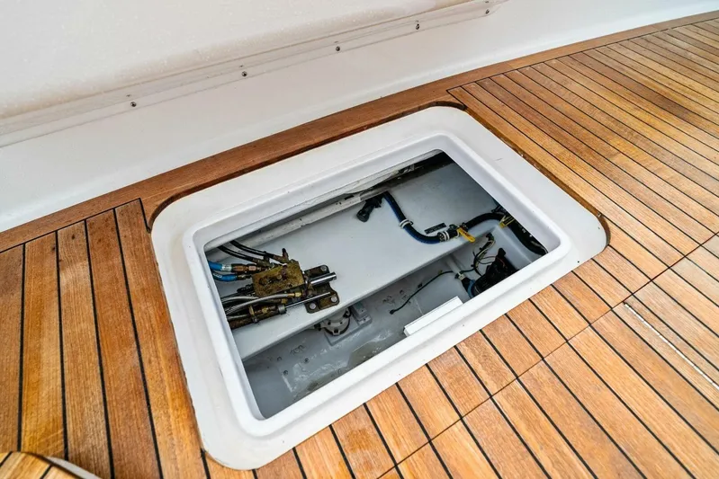 Knot On Call Yacht Photos Pics Open hatch on 2006 Viking 61 Convertible yacht deck, revealing internal components.