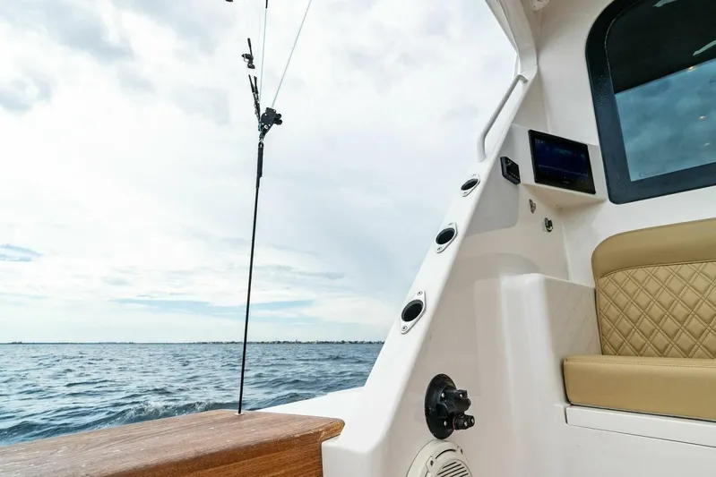 Knot On Call Yacht Photos Pics 2006 Viking 61 Convertible boat interior with ocean view, featuring seating and fishing rod holder.