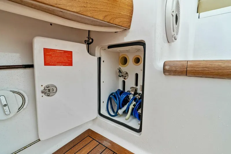 Knot On Call Yacht Photos Pics Open storage compartment on 2006 Viking 61 Convertible yacht with hoses and fittings.