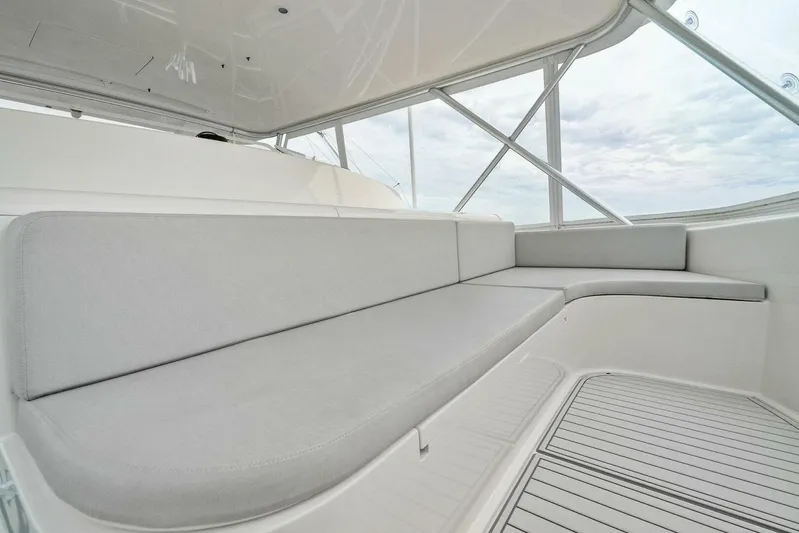 Knot On Call Yacht Photos Pics Spacious seating area on 2006 Viking 61 Convertible yacht, featuring sleek design and comfortable cushions.