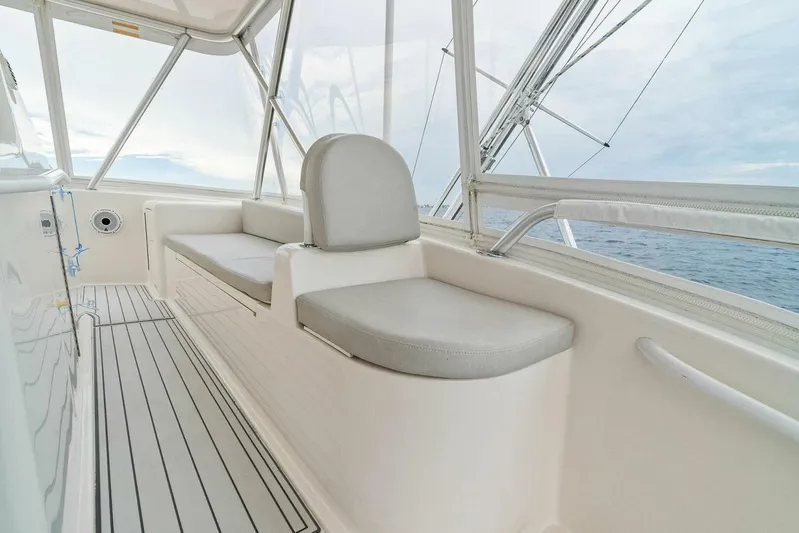 Knot On Call Yacht Photos Pics Interior view of 2006 Viking 61 Convertible yacht with cushioned seating and ocean backdrop.