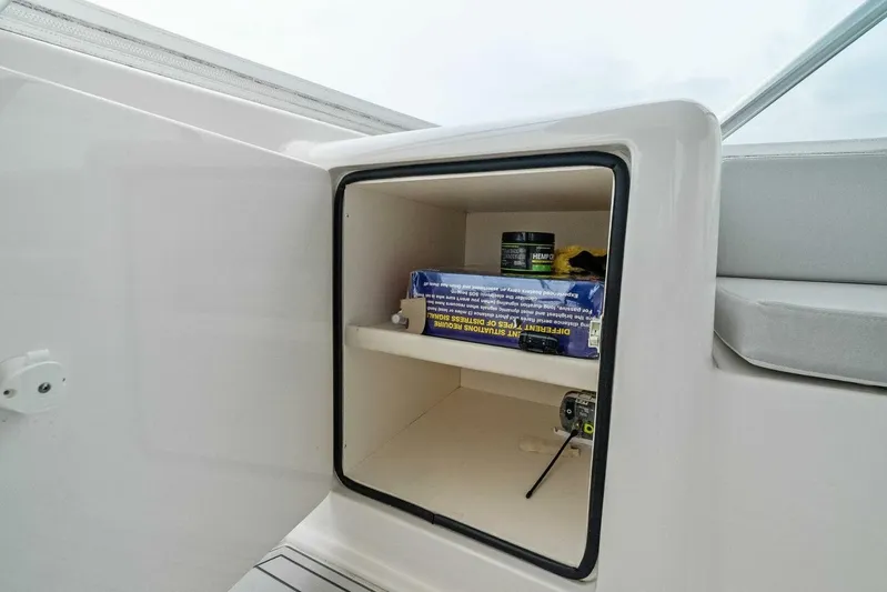 Knot On Call Yacht Photos Pics Open storage compartment on 2006 Viking 61 Convertible yacht, containing various items.