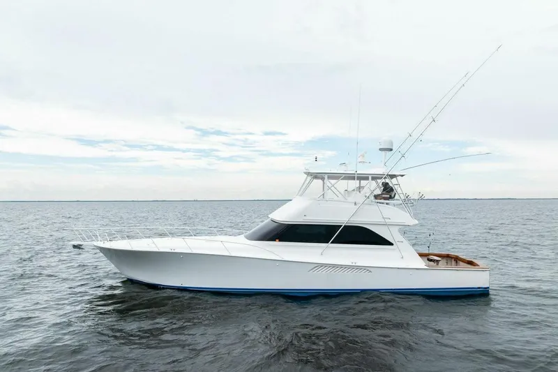 Knot On Call Yacht Photos Pics 2006 Viking 61 Convertible yacht on open water, showcasing sleek design and fishing equipment.