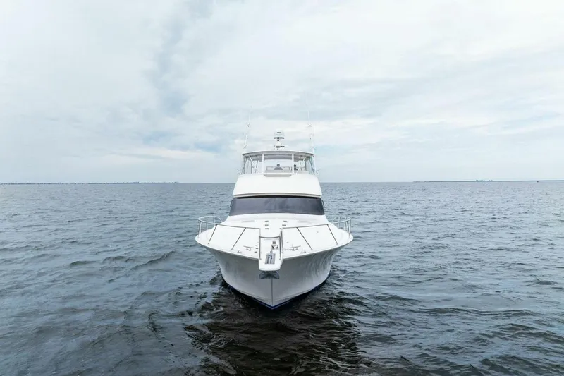 Knot On Call Yacht Photos Pics 2006 Viking 61 Convertible yacht on open water under cloudy sky.