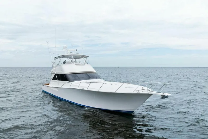 Knot On Call Yacht Photos Pics 2006 Viking 61 Convertible yacht cruising on open water under cloudy skies.