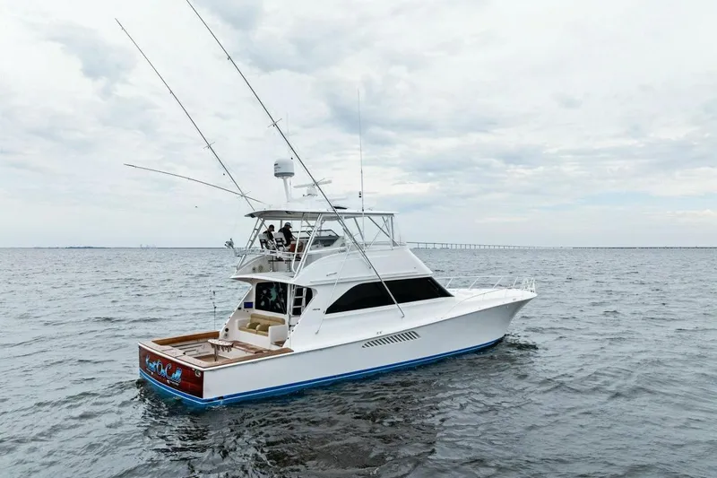 Knot On Call Yacht Photos Pics 2006 Viking 61 Convertible yacht on open water, featuring fishing rods and spacious deck.