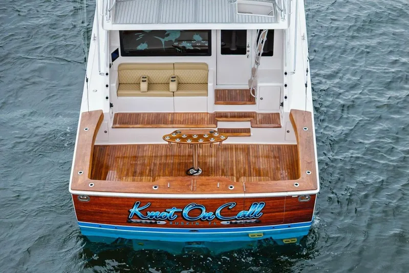 Knot On Call Yacht Photos Pics 2006 Viking 61 Convertible yacht with wooden deck, named "Knot On Call," on water.