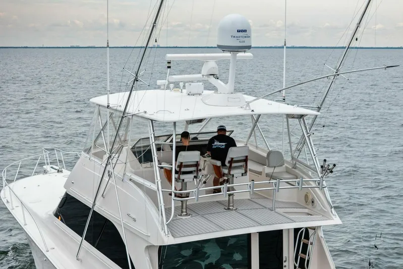 Knot On Call Yacht Photos Pics 2006 Viking 61 Convertible yacht on open water, featuring upper deck and fishing equipment.