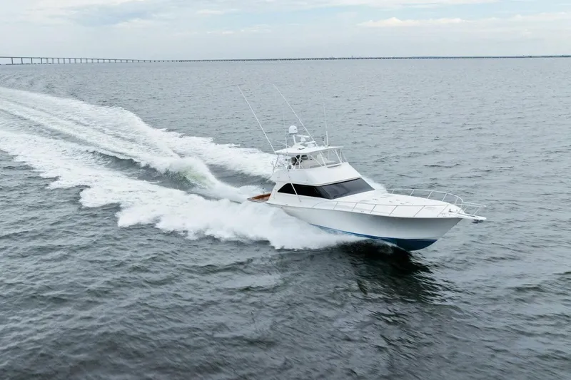 Knot On Call Yacht Photos Pics 2006 Viking 61 Convertible yacht cruising swiftly on open water.