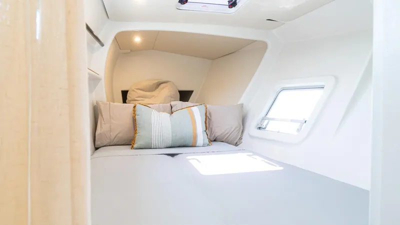 Nohea Yacht Photos Pics Cozy cabin interior of 2022 Custom Current Marine 46 yacht with modern bedding.