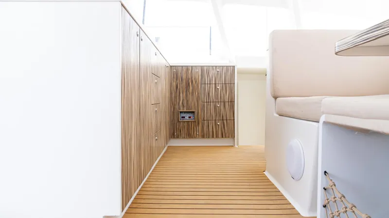 Nohea Yacht Photos Pics Modern interior of 2022 Custom Current Marine 46 yacht with wood paneling and seating.