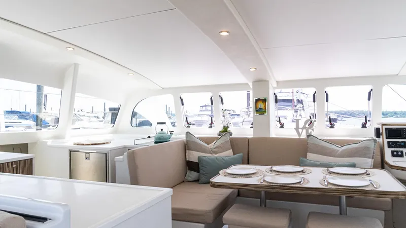 Nohea Yacht Photos Pics Luxurious interior of 2022 Custom Current Marine 46 yacht with elegant dining area.