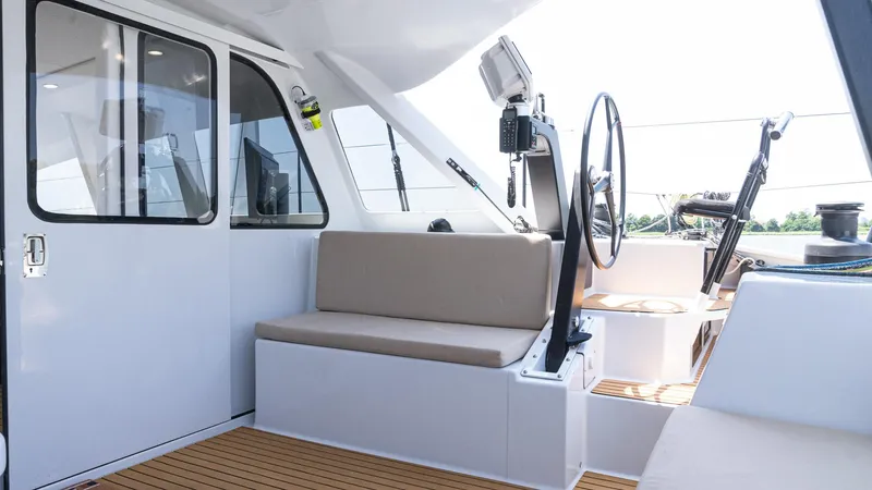 Nohea Yacht Photos Pics Custom Current Marine 46 yacht interior, 2022 model, featuring seating and steering wheel.
