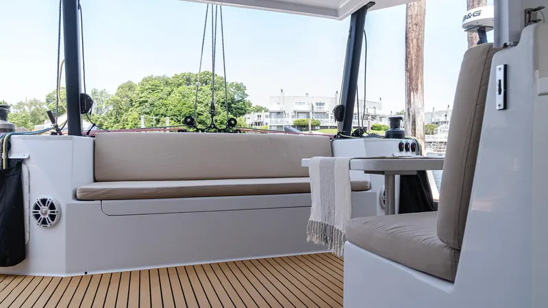 Nohea Yacht Photos Pics Modern 2022 Custom Marine 46 yacht interior with seating and wooden deck.