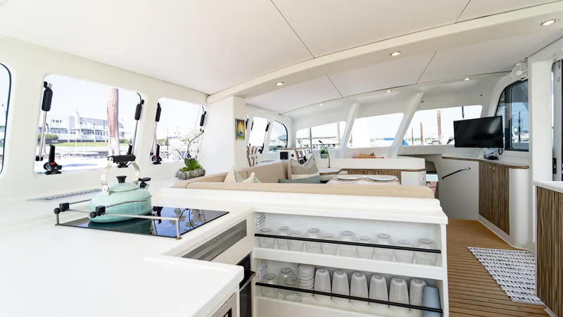 Nohea Yacht Photos Pics Luxurious interior of 2022 Custom Current Marine 46 yacht with modern kitchen and seating area.