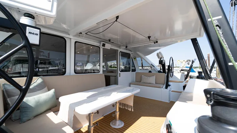 Nohea Yacht Photos Pics Spacious interior of 2022 Custom Current Marine 46 yacht with seating and table.
