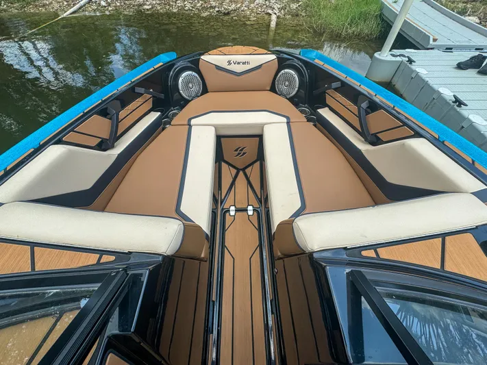  Yacht Photos Pics 2024 Varatti Z2373 boat interior with tan and black seating, docked by the water.