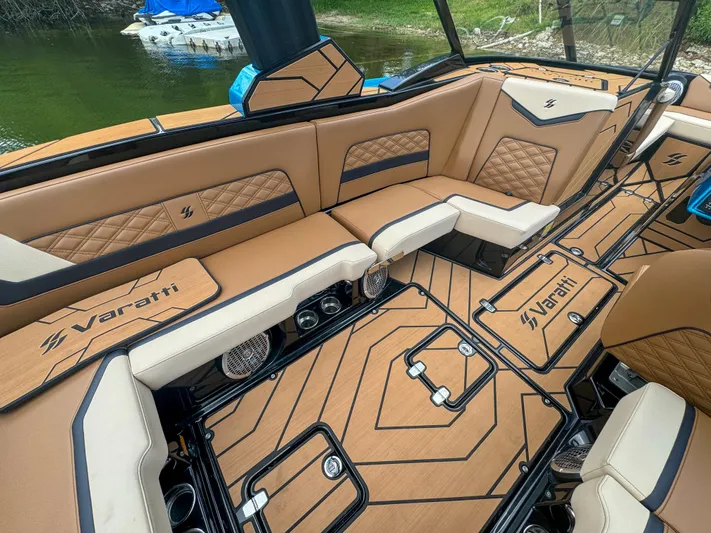  Yacht Photos Pics 2024 Varatti Z2373 boat interior with tan and black seating, custom flooring, and lake backdrop.