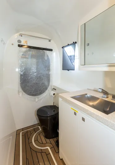 Cui Bono Yacht Photos Pics Modern bathroom in 2015 Gunboat 60 yacht with sleek fixtures and wooden flooring.