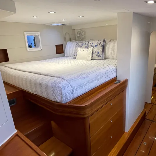 Cui Bono Yacht Photos Pics Luxurious bedroom interior of 2015 Gunboat 60 yacht with elegant bedding and wooden accents.