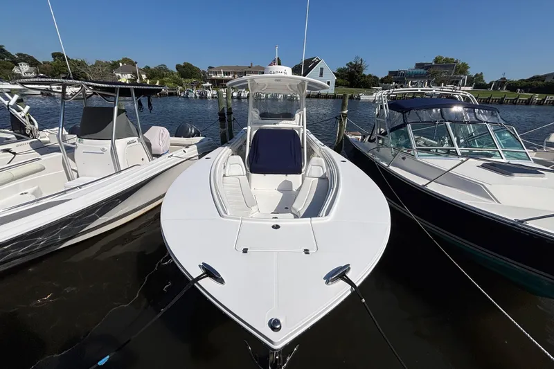  Yacht Photos Pics 2017 Regulator 28 boat docked between two other boats on a sunny day.