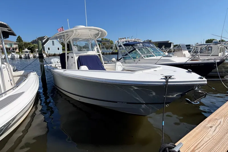  Yacht Photos Pics 2017 Regulator 28 boat docked in a marina under clear blue skies.