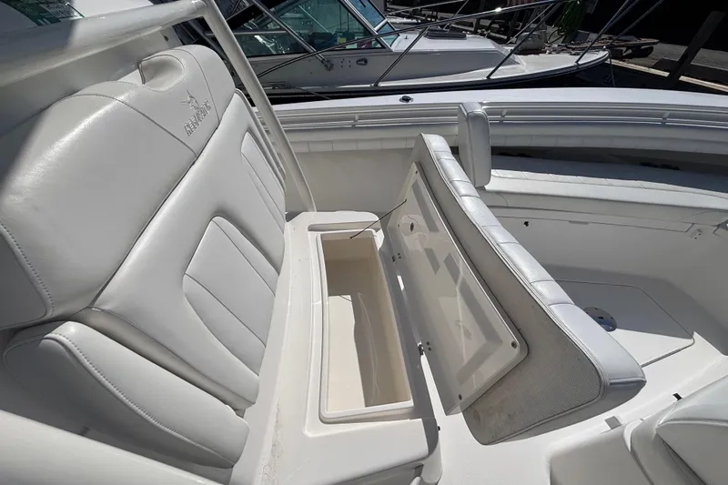  Yacht Photos Pics 2017 Regulator 28 boat with open storage compartment and white cushioned seating.