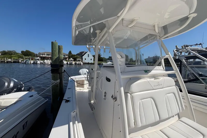  Yacht Photos Pics 2017 Regulator 28 boat docked, featuring sleek white design and spacious seating.