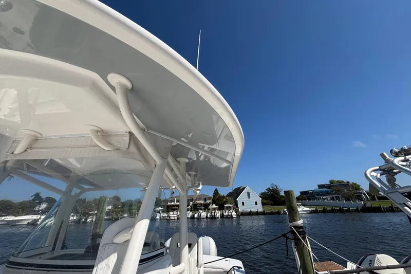  Yacht Photos Pics 2017 Regulator 28 boat docked by waterfront homes under clear blue sky.
