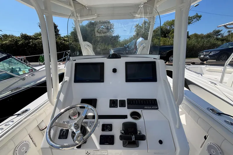  Yacht Photos Pics 2017 Regulator 28 boat dashboard with dual screens and steering wheel.