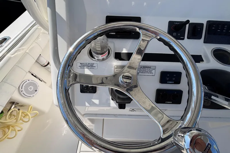  Yacht Photos Pics Steering wheel of a 2017 Regulator 28 boat with control panel and throttle.