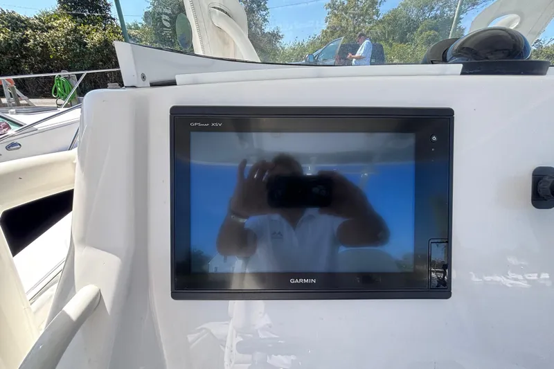  Yacht Photos Pics Garmin GPS display on 2017 Regulator 28 boat dashboard, reflecting surroundings.