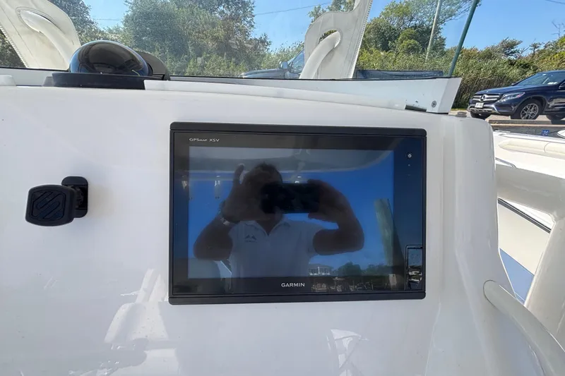  Yacht Photos Pics Garmin GPSMAP XSV on 2017 Regulator 28 boat dashboard, reflecting surroundings.