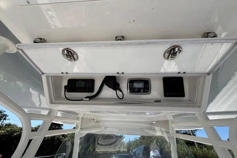  Yacht Photos Pics 2017 Regulator 28 boat console with electronic equipment and storage compartment.