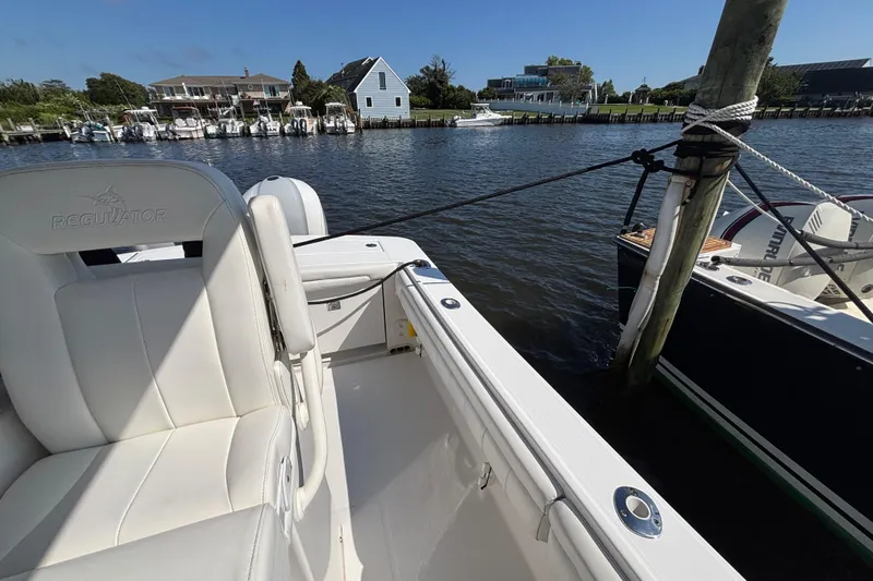  Yacht Photos Pics 2017 Regulator 28 boat docked in a scenic marina with waterfront homes.