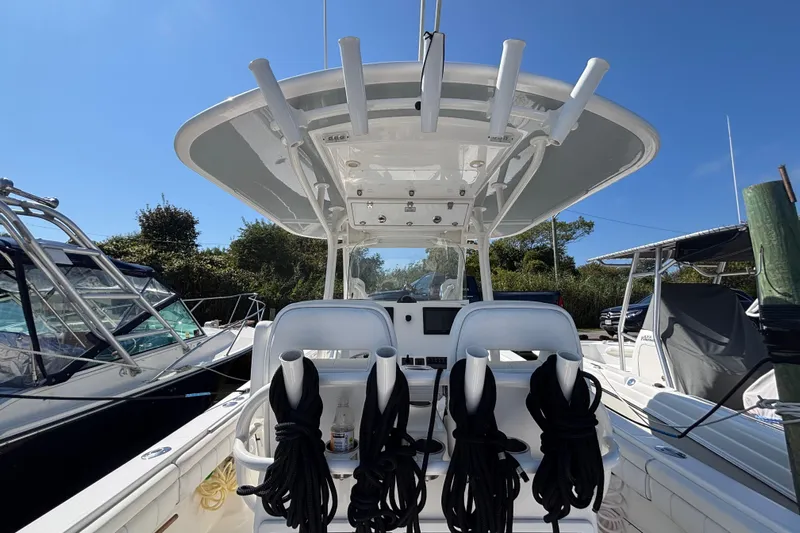  Yacht Photos Pics 2017 Regulator 28 boat interior with helm station and seating, docked under clear blue sky.