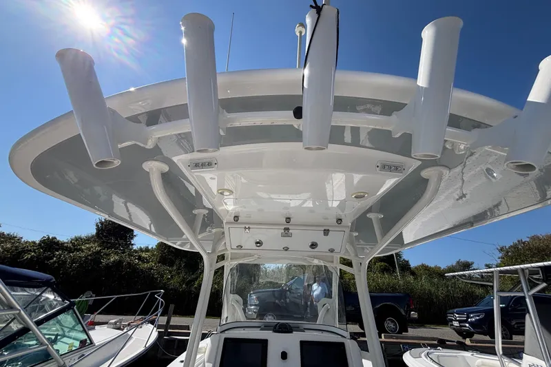  Yacht Photos Pics 2017 Regulator 28 boat with T-top and rod holders under clear blue sky.