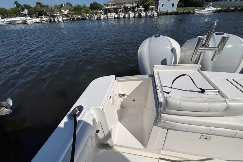  Yacht Photos Pics 2017 Regulator 28 boat stern view with dual engines, docked near waterfront homes.
